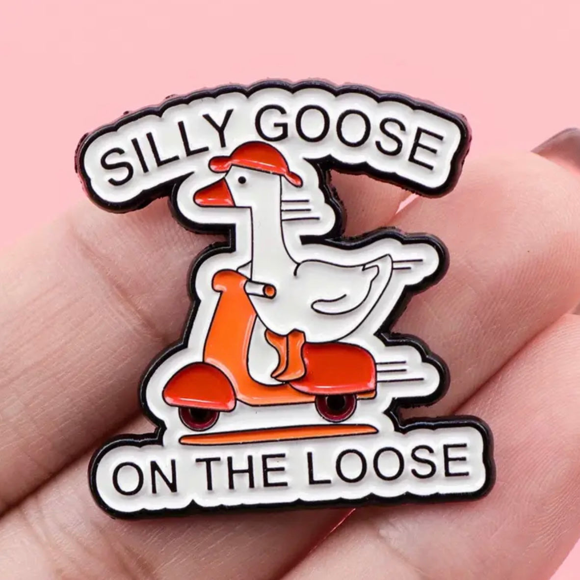 Pin with a goose on a scooter and text 'Silly Goose on the Loose' held in hand against pink background